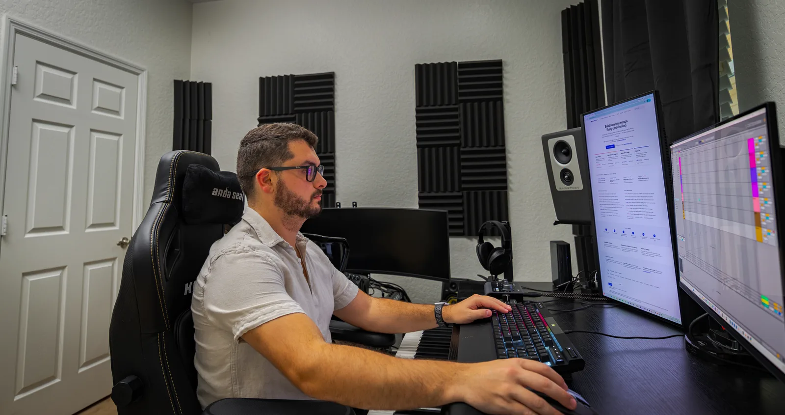 Kyle Romero working in his acoustically-treated home studio — Barefoot monitors, a condenser mic, and a DAW session open
